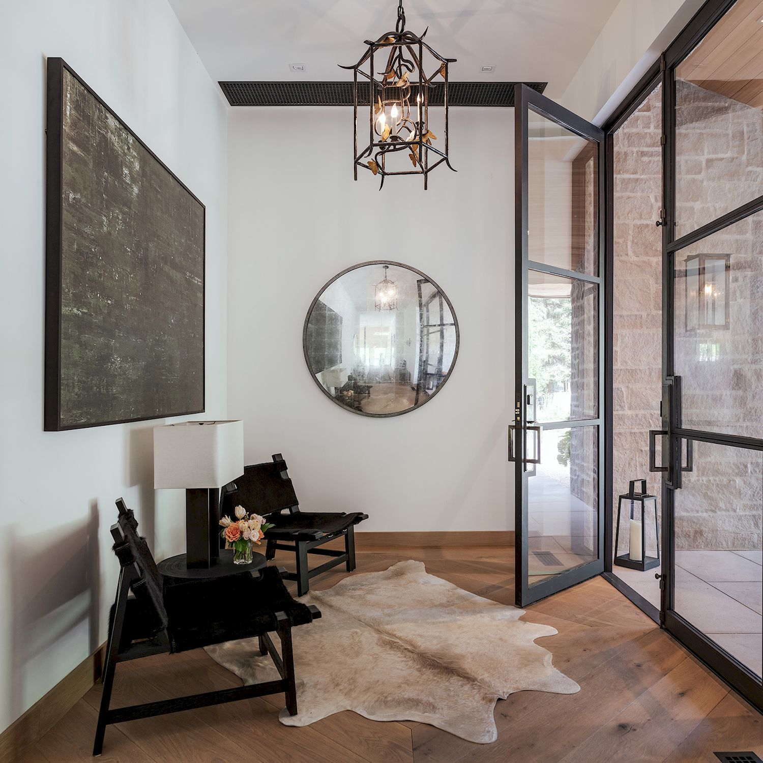 Modern entryway with cowhide rug and mirror